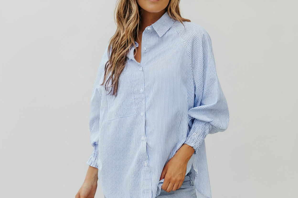 This beautiful and versatile blue striped blouse is a must for any boutiques inventory.  Pairs will with neutral palettes.