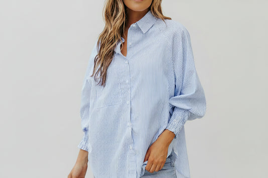 This beautiful and versatile blue striped blouse is a must for any boutiques inventory.  Pairs will with neutral palettes.
