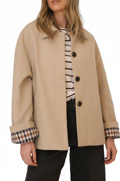 Neutral parchement and plaid short trench coat for your on-the-go customer.  Classic plaid lining and folding sleeves, pockets and buttons with hidden placket creates a timeless and versatile look on any body type.