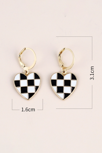 Heart-shaped checkered earrings with gold hooks on a light pink background